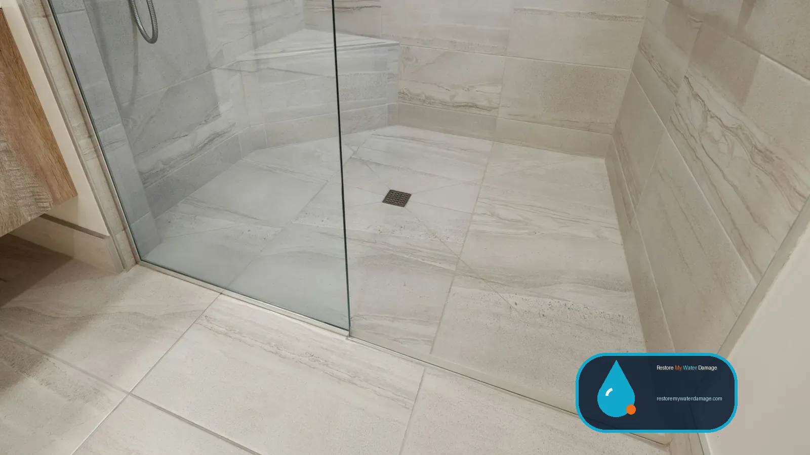 Tiled shower floor with a center drain, where backups lead to water damage restoration Carrollton Lewisville, TX