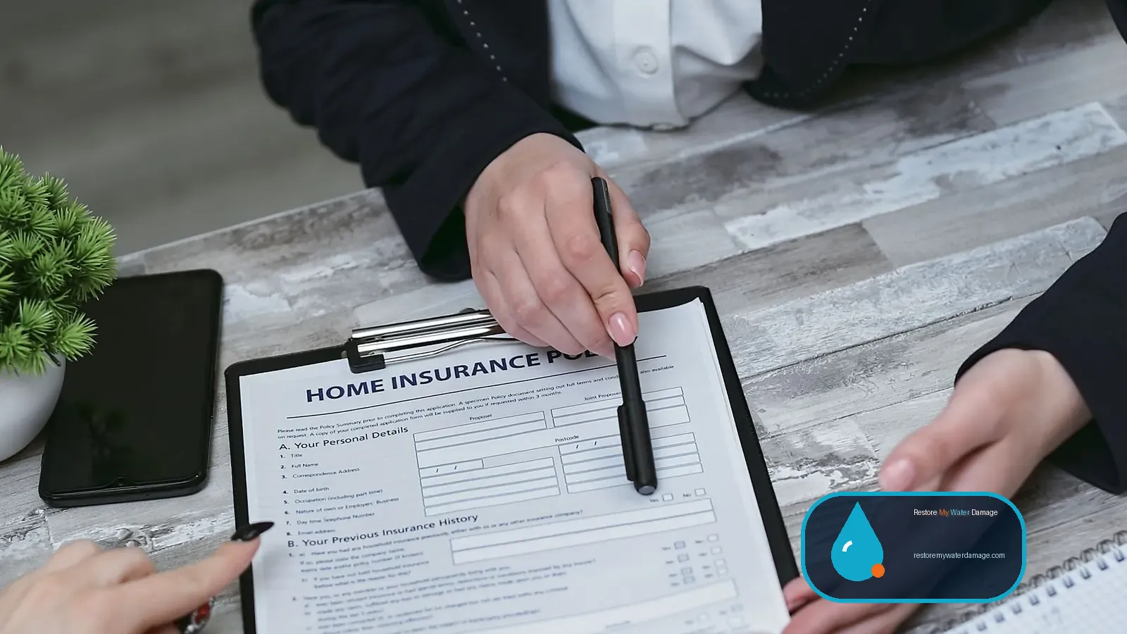 Homeowner and professional reviewing a written estimate for water damage restoration near me