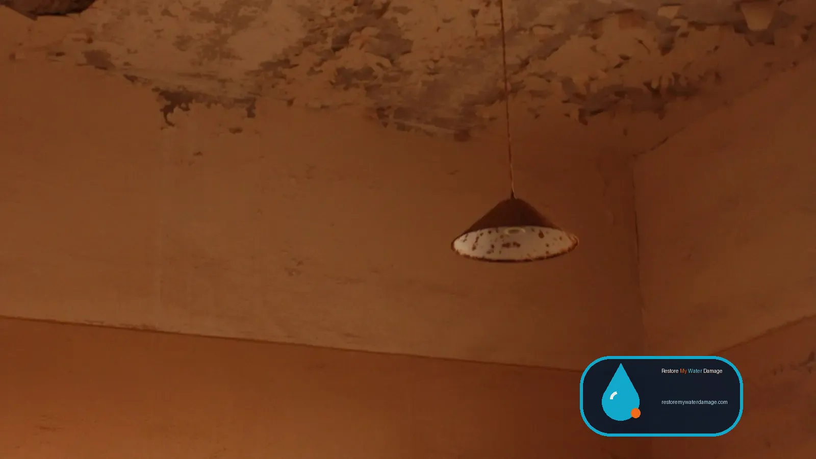 Stained and peeling ceiling above an empty room, a sign needing water damage restoration in Nevada